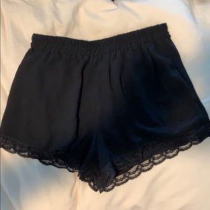Mid rise black flowy shorts with lace trim